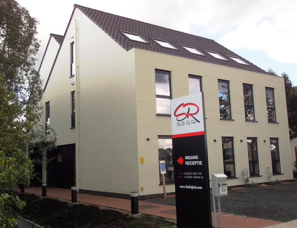 a building with a sign in front of it at BenBSjeRie in Maldegem