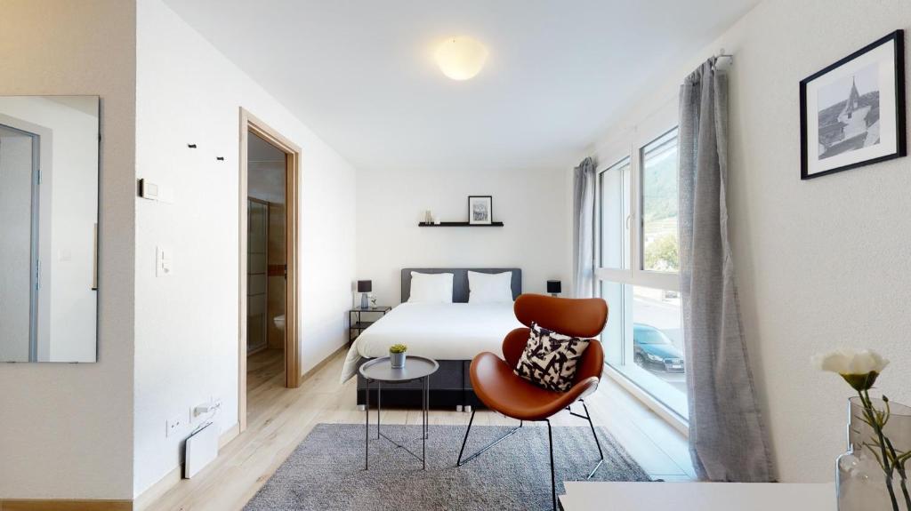 Uma cama ou camas num quarto em Nonanteneuf appart hōtel Aigle - contactless check-in