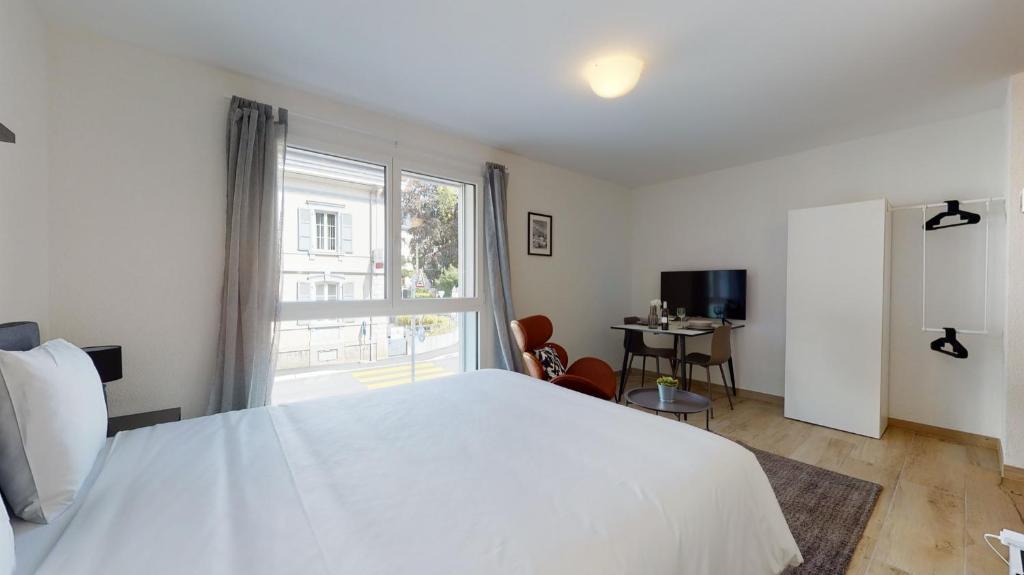 Uma cama ou camas num quarto em Nonanteneuf appart hōtel Aigle - contactless check-in