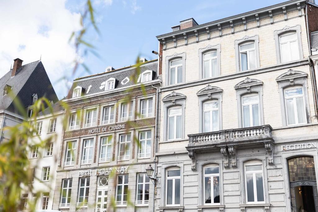 a large white building with many windows at Petit-Roannay in Stavelot