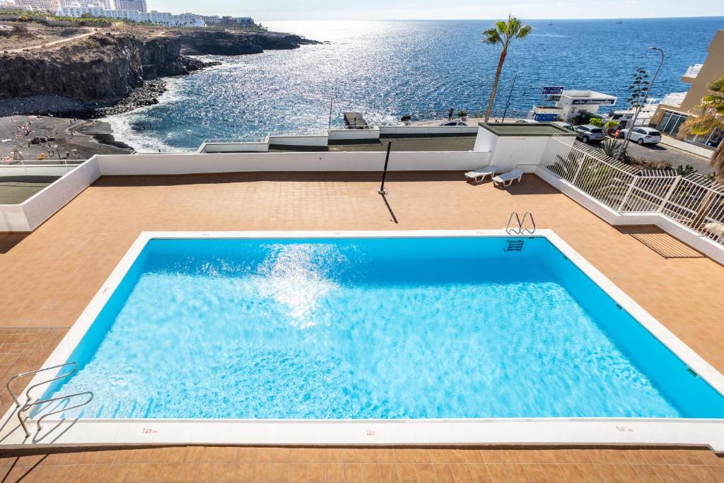 a swimming pool with a view of the ocean at The Blue Anchor SPECTACULAR SEA VIEW in Callao Salvaje
