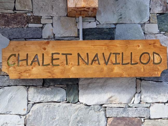 a wooden sign on a brick wall with the word chalkived at Chalet Navillod in Tignes