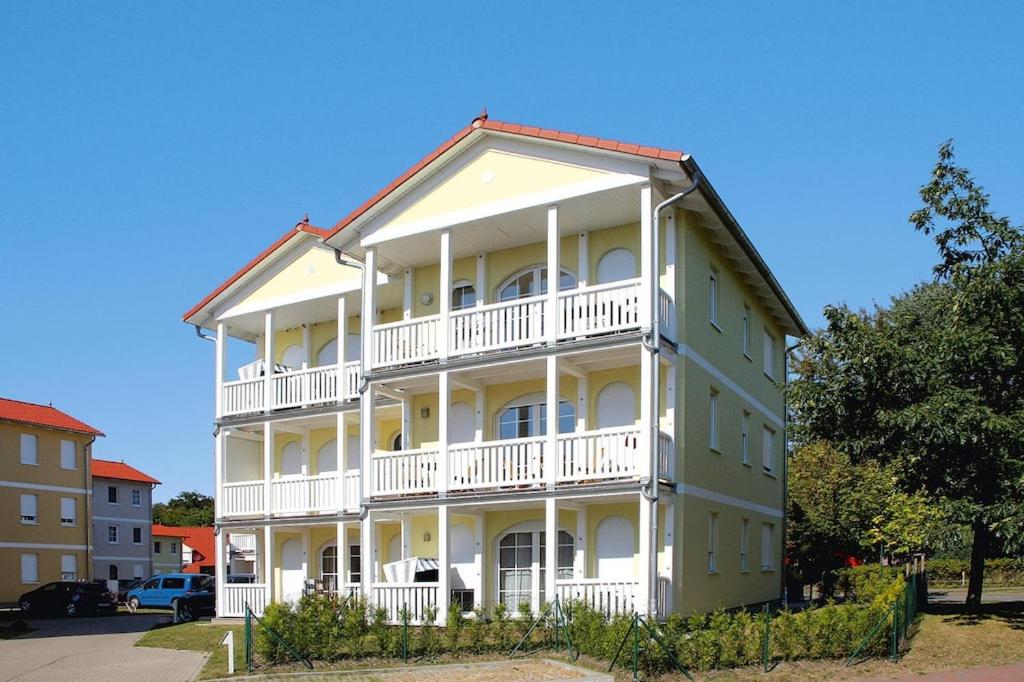 a large white building with a white balcony at Apartment, Graal-Müritz in Graal-Müritz