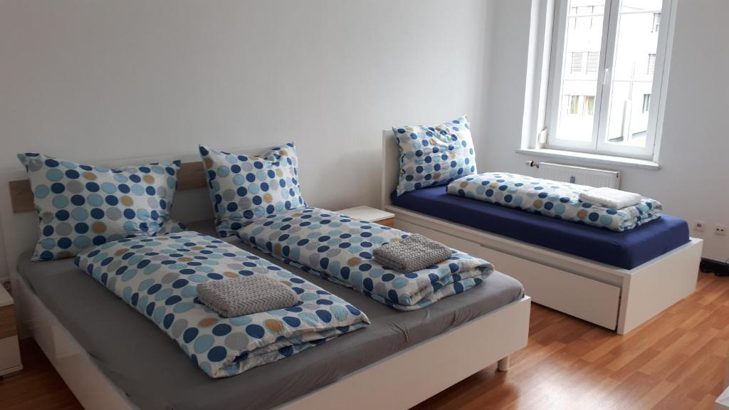 a living room with a couch with polka dot pillows at City Appartment Orlitsch in Klagenfurt