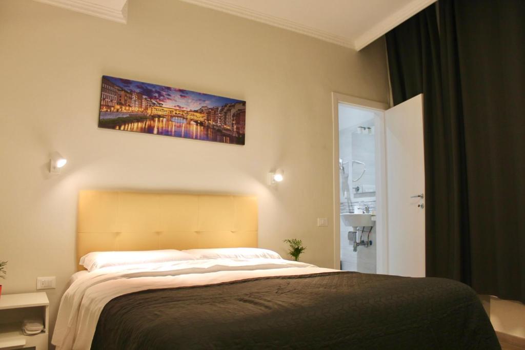 Postel nebo postele na pokoji v ubytování Hotel 900 Toscana