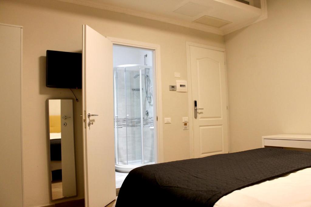 Postel nebo postele na pokoji v ubytování Hotel 900 Toscana