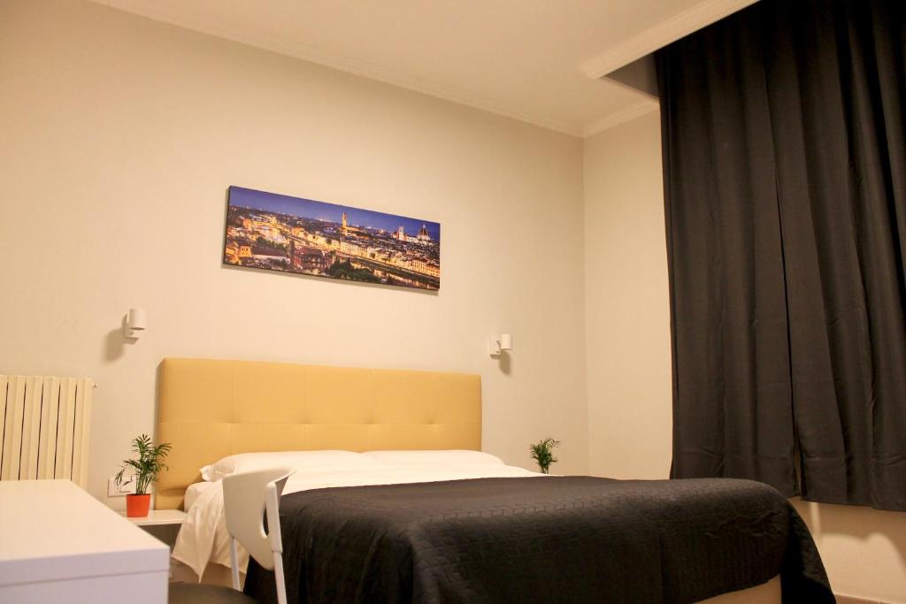 Postel nebo postele na pokoji v ubytování Hotel 900 Toscana