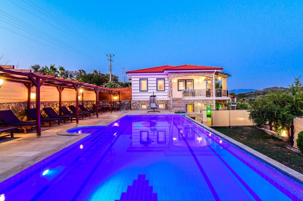 a swimming pool in front of a house at Villa Bellevue in Karadere