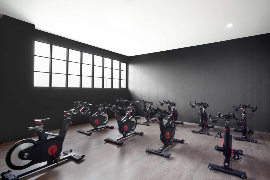 a gym with a bunch of exercise bikes at Radisson Lampung Kedaton in Bandar Lampung