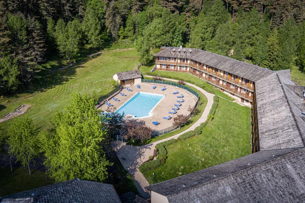 an aerial view of a house with a swimming pool at Les Hameaux De Lozere Sure Hotel Collection by Best Western in Fournels