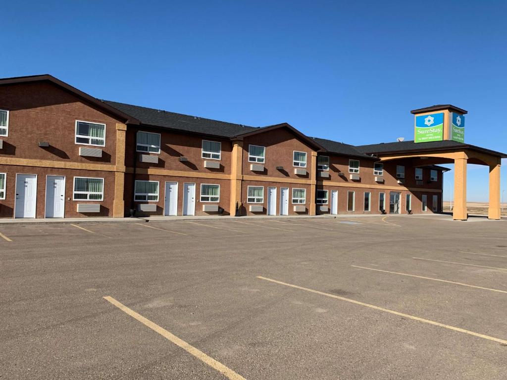 an empty parking lot in front of a hotel at SureStay Hotel by Best Western Bassano in Bassano