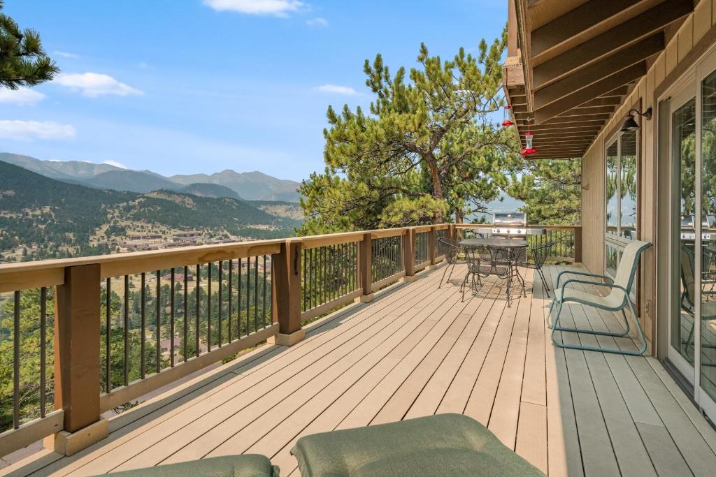 a deck with chairs and a table with a view at Solitude Vacation Home at Windcliff home in Estes Park