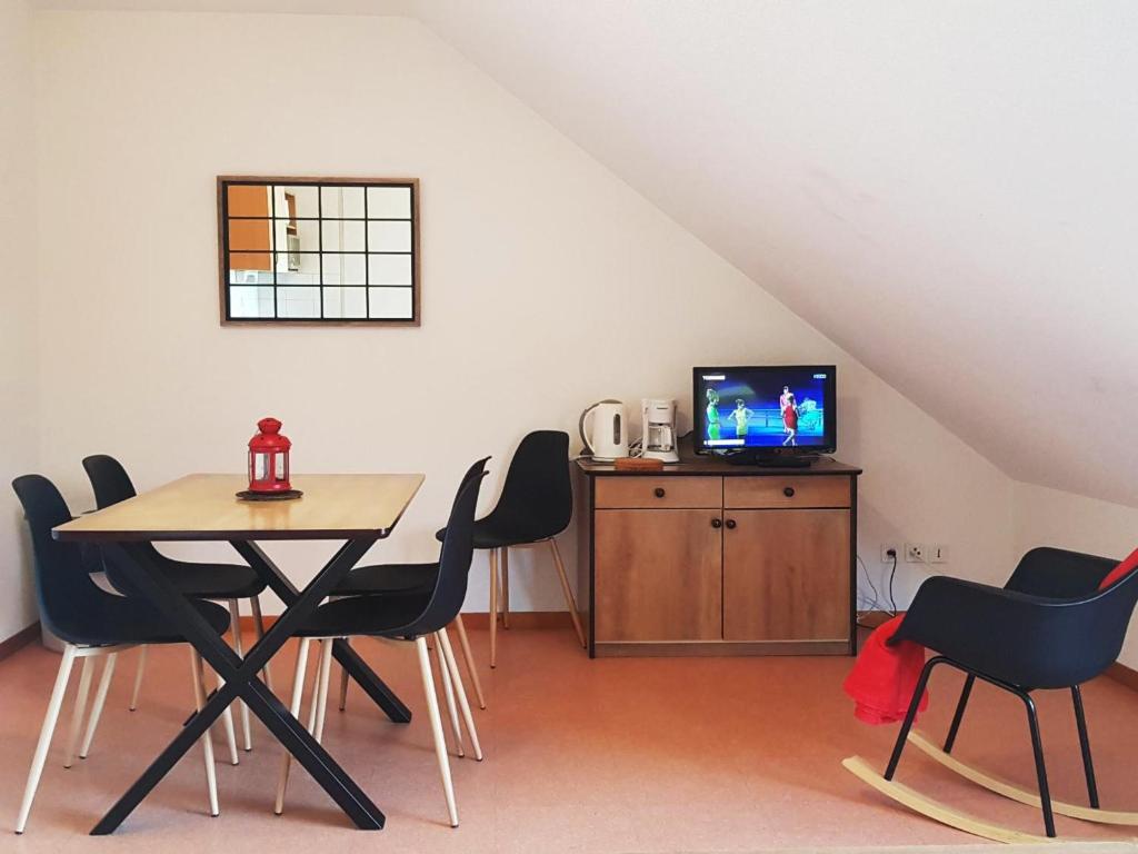 a dining room with a table and chairs and a television at Appartement Saint-François-Longchamp, 2 pièces, 4 personnes - FR-1-635-10 in Saint-François-Longchamp