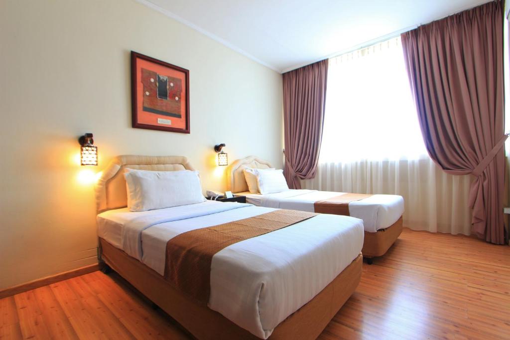 Postel nebo postele na pokoji v ubytování Telang Usan Hotel Kuching