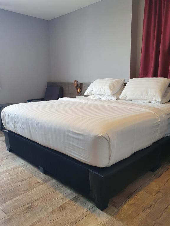 Postel nebo postele na pokoji v ubytování See Foo Hotel