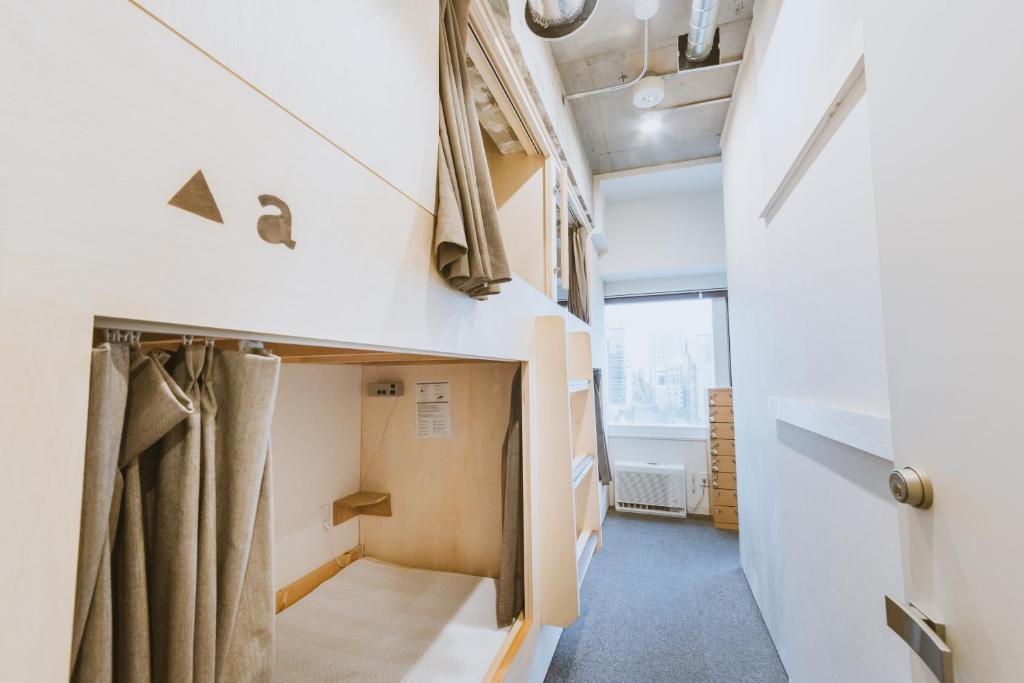 Postel nebo postele na pokoji v ubytování Grand Hostel LDK Sapporo
