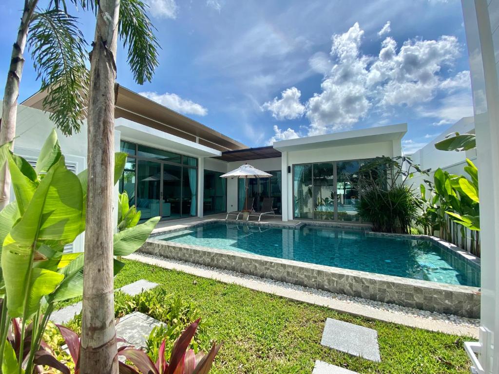 a swimming pool in the backyard of a villa at Bliss Villa at Shambhala Grand in Bang Tao Beach