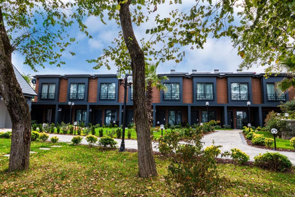 an exterior view of a building with trees at SANTANA OTEL in Trabzon