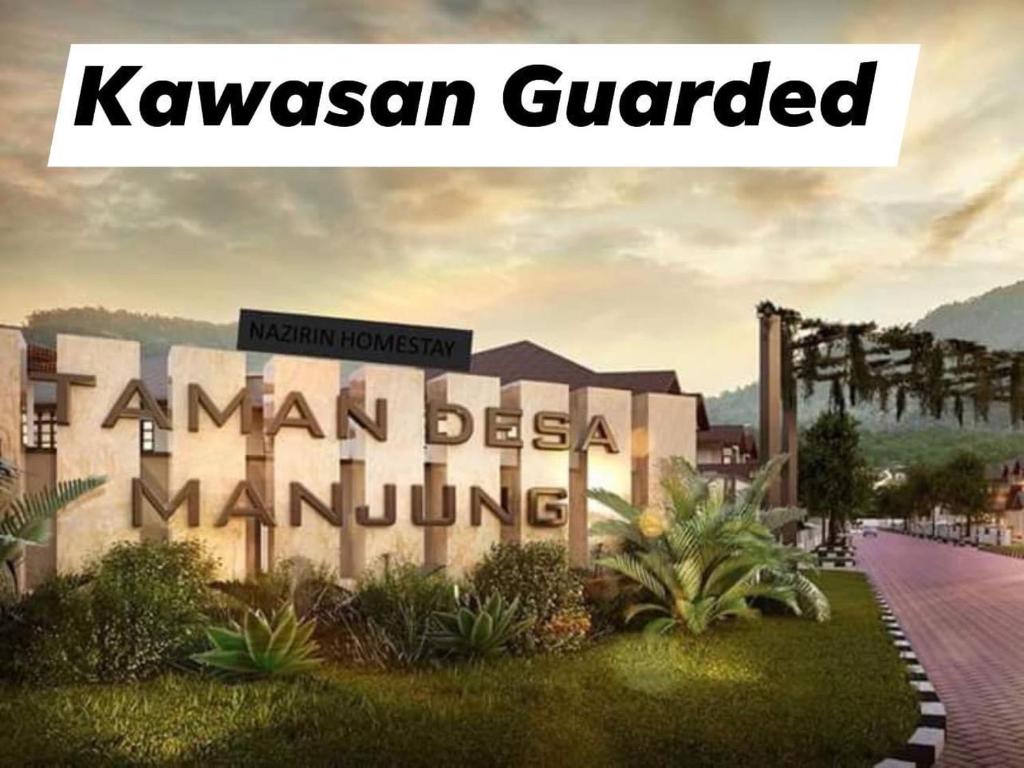 a sign that reads kawasaki guadalamed in front of a building at No 11 Nazirin Homestay Tmn Desa Manjung Lumut in Lumut
