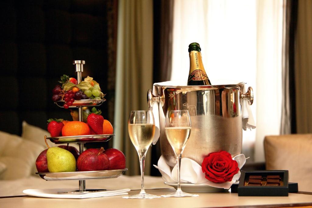 a table with a bottle of champagne and two glasses at Hotel St.Gotthard in Zürich