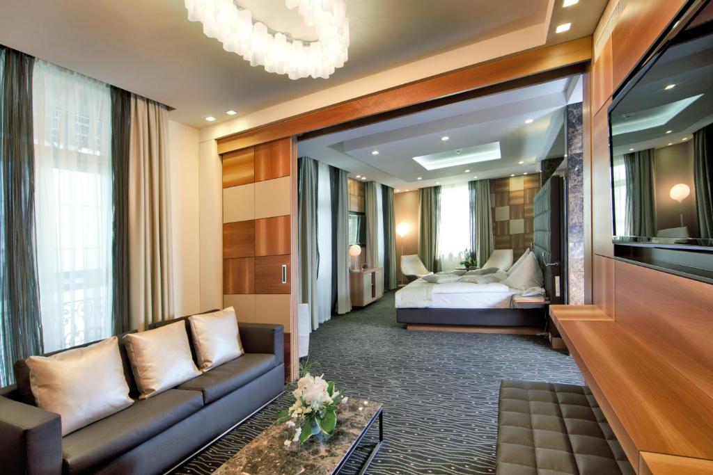 a hotel room with a couch and a bed at Hotel St.Gotthard in Zürich