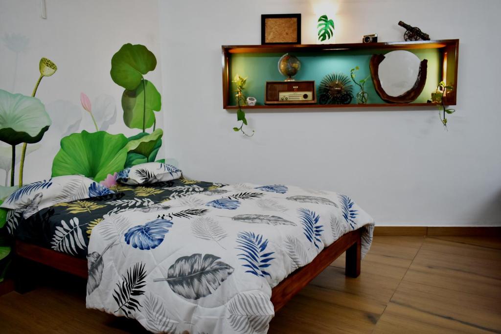 - une chambre avec un lit et un miroir mural dans l'établissement LE SUNSHINE RESIDENCY, à Pondichéry