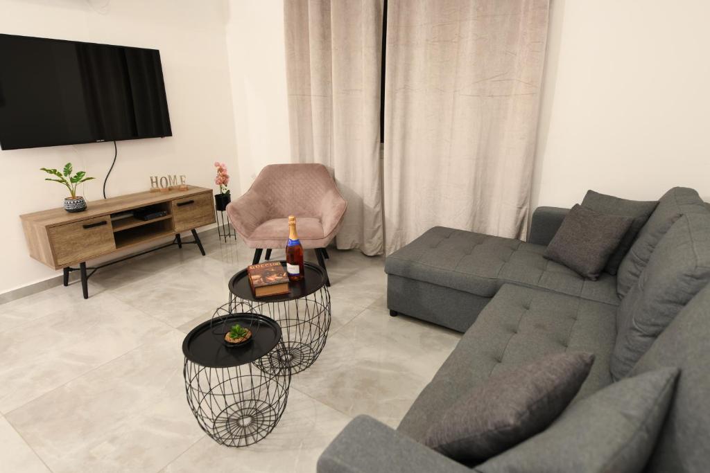 a living room with a couch and a tv at MAKAZA neviot in Eilat