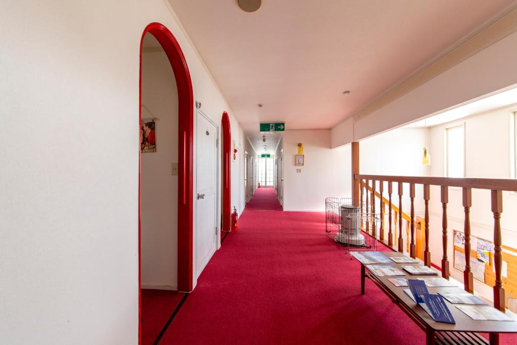a hallway with a red carpet and a red corridor at Summer Leaves in Hakuba