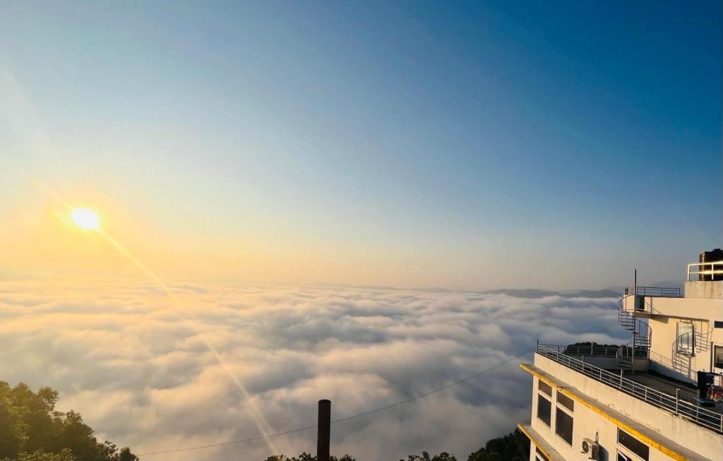 a view of the sun rising above a sea of clouds at Le Glamour Luxury Resort & Wellness Spa Pvt Ltd in Pokhara
