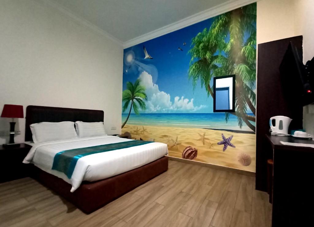a bedroom with a bed and a painting of a beach at Comfort Hotel in Kota Kinabalu