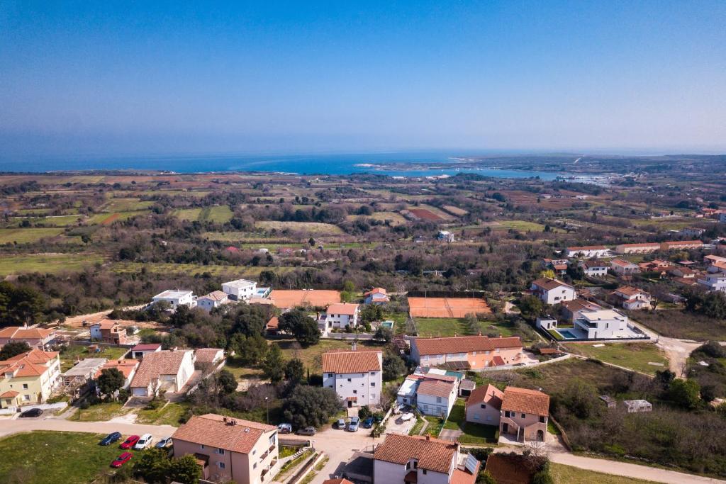 an aerial view of a small town with houses and the ocean at SEA VIEW APARTMENT in Ližnjan