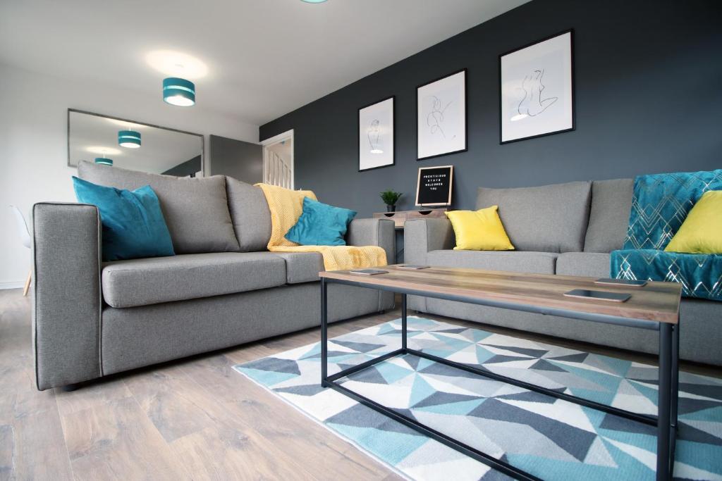 a living room with a couch and a coffee table at DELFT - Spacious Home, High Speed Wi-Fi, Free Parking, Terrace in Swindon
