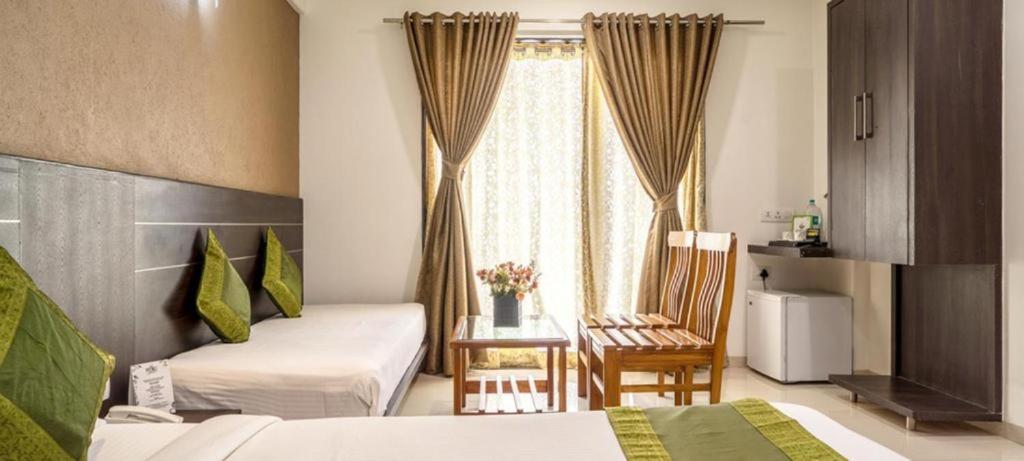 Postel nebo postele na pokoji v ubytování Pushpak Resort