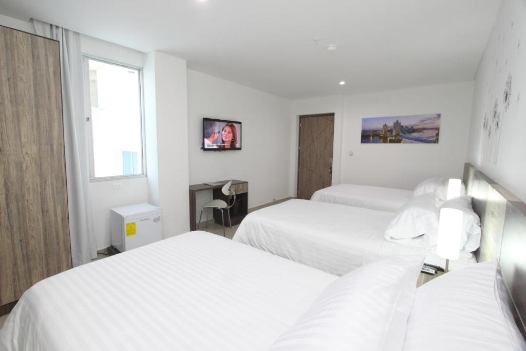 Postel nebo postele na pokoji v ubytování Hotel Oxford Barranquilla