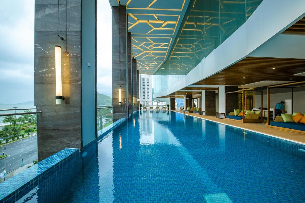 a swimming pool in the middle of a building at FLC City Hotel Beach Quy Nhon in Quy Nhon