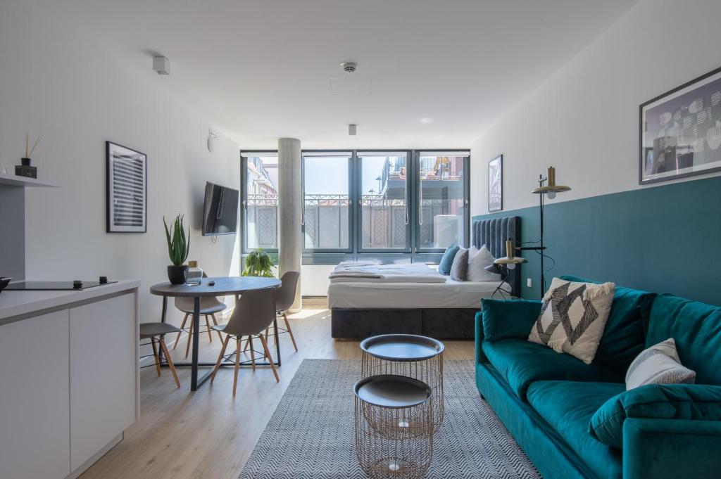 a living room with a couch and a table at Limehome Flensburg Holm in Flensburg