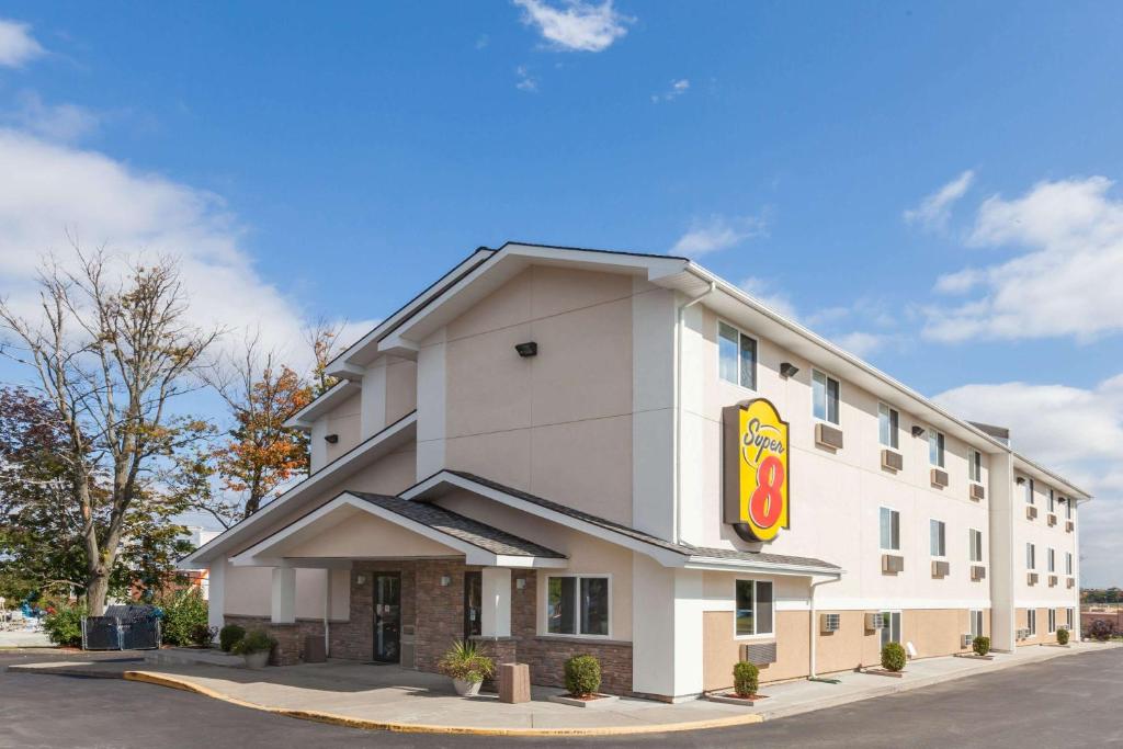 a hotel building with a fast food restaurant at Super 8 by Wyndham Latham - Albany Airport in Latham