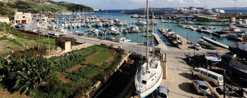 a harbor filled with lots of boats in the water at Mgarr Waterfront Cosy Apartment 3 by Ghajnsielem Gozo in Mġarr