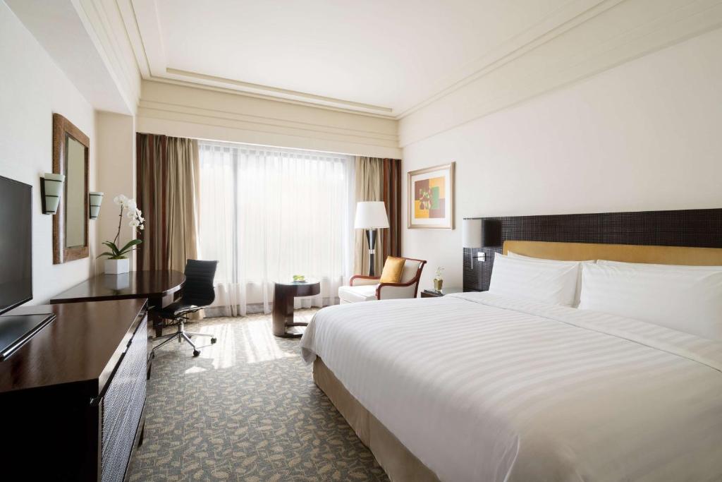 Postel nebo postele na pokoji v ubytování Edsa Shangri-La, Manila
