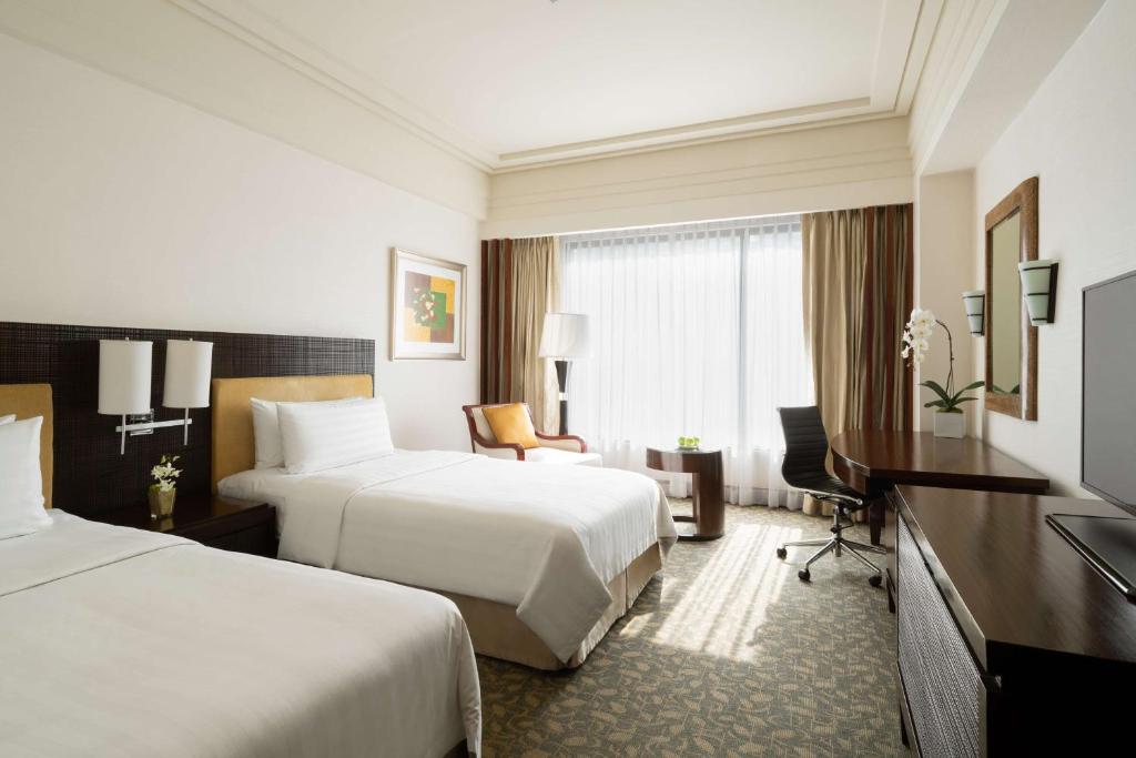 Postel nebo postele na pokoji v ubytování Edsa Shangri-La, Manila