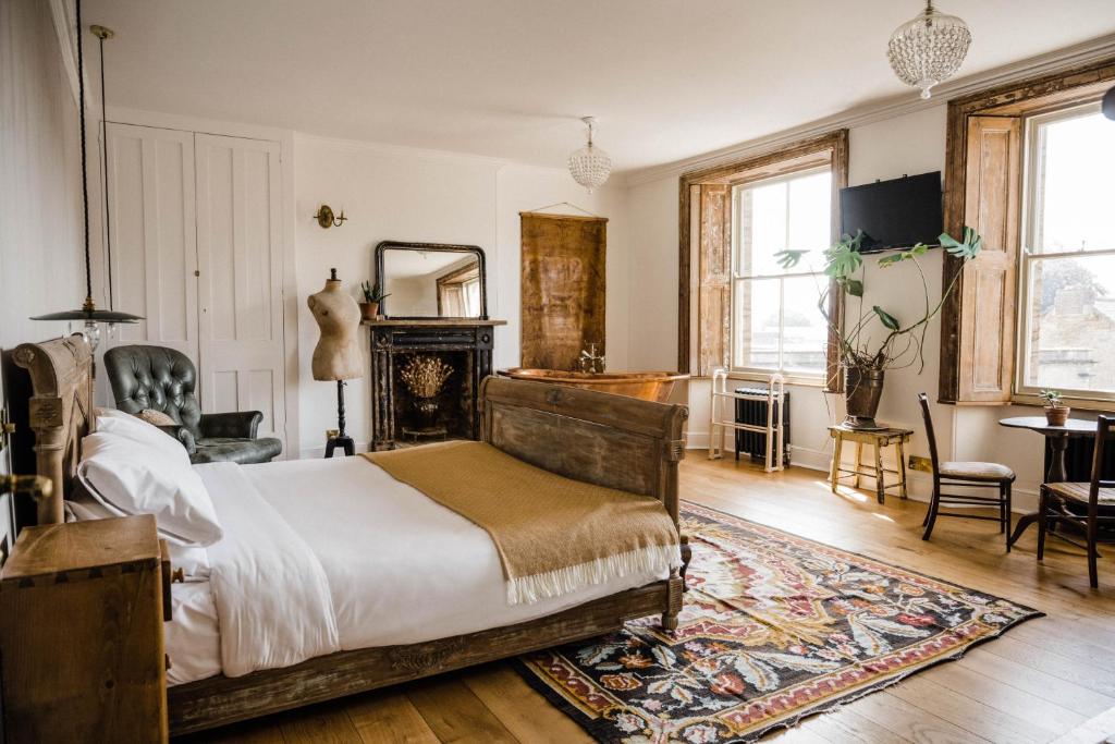 a bedroom with a bed and a rug at The Crooked Swan in Crewkerne