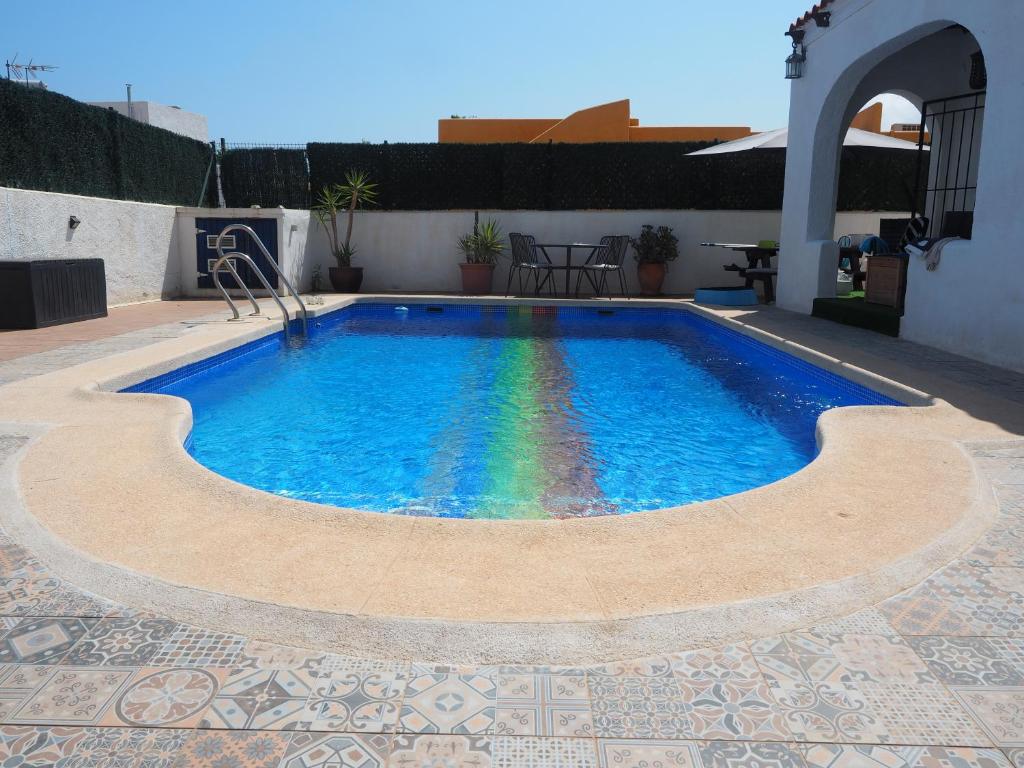 a swimming pool with a rainbow in the middle at Casa Rainbow - Boutique Bed & Breakfast in Mojácar