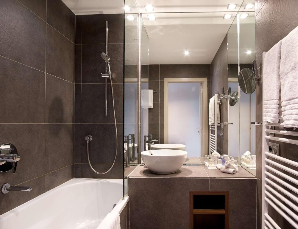 a bathroom with a bath tub and a sink at Radisson BLU Balmoral in Spa
