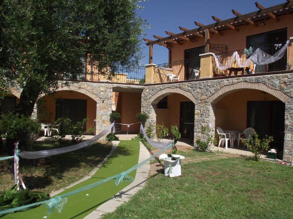 a house with a garden in front of it at Park Hotel Cilento in Marina di Camerota