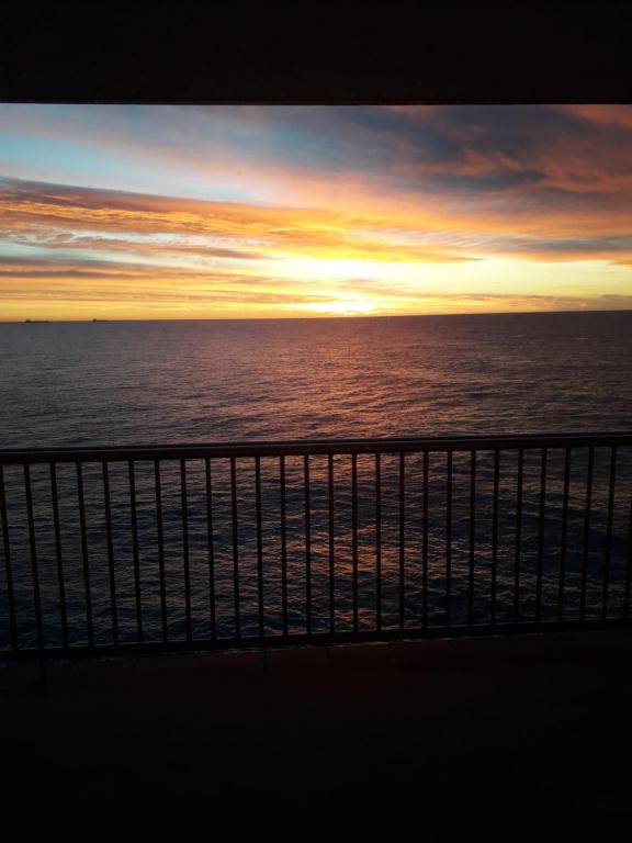 a view of the ocean at sunset from a cruise ship at jacuzzi & sauna apartment ! in Salou