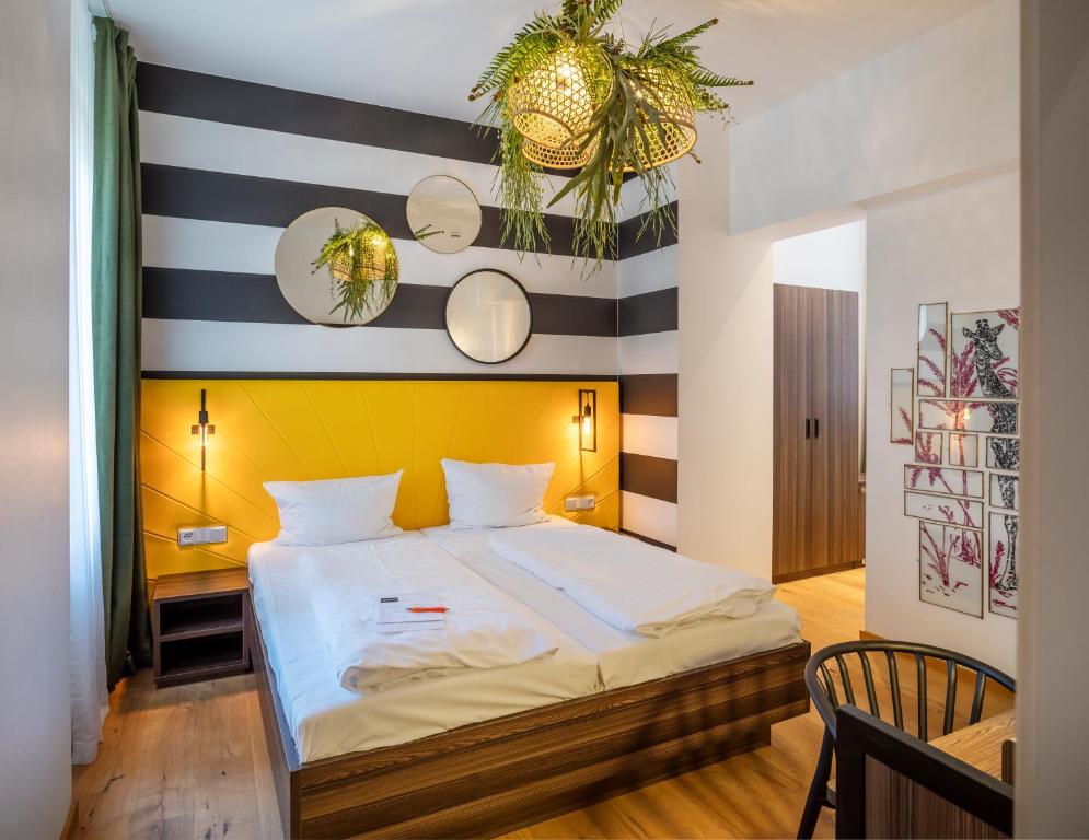 a bedroom with a bed with a striped wall at acor Boutique Hotel in Heidelberg