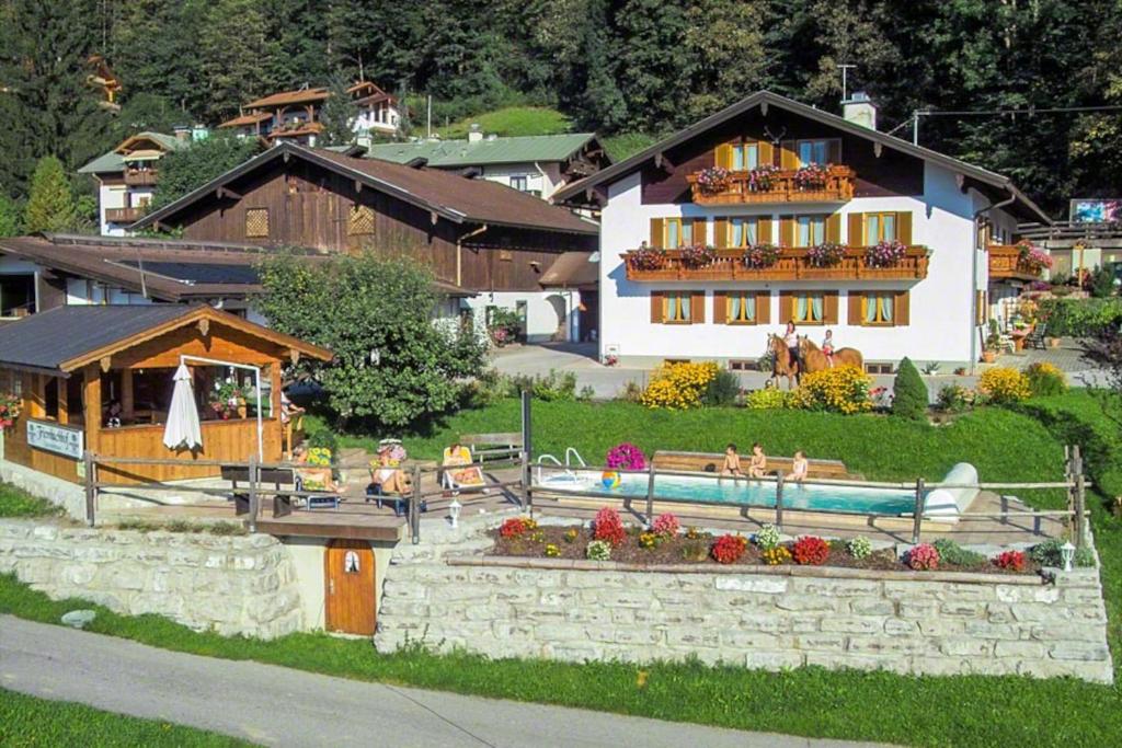 a house with a swimming pool in front of it at Ferienwohnung Triembachhof in Schönau am Königssee