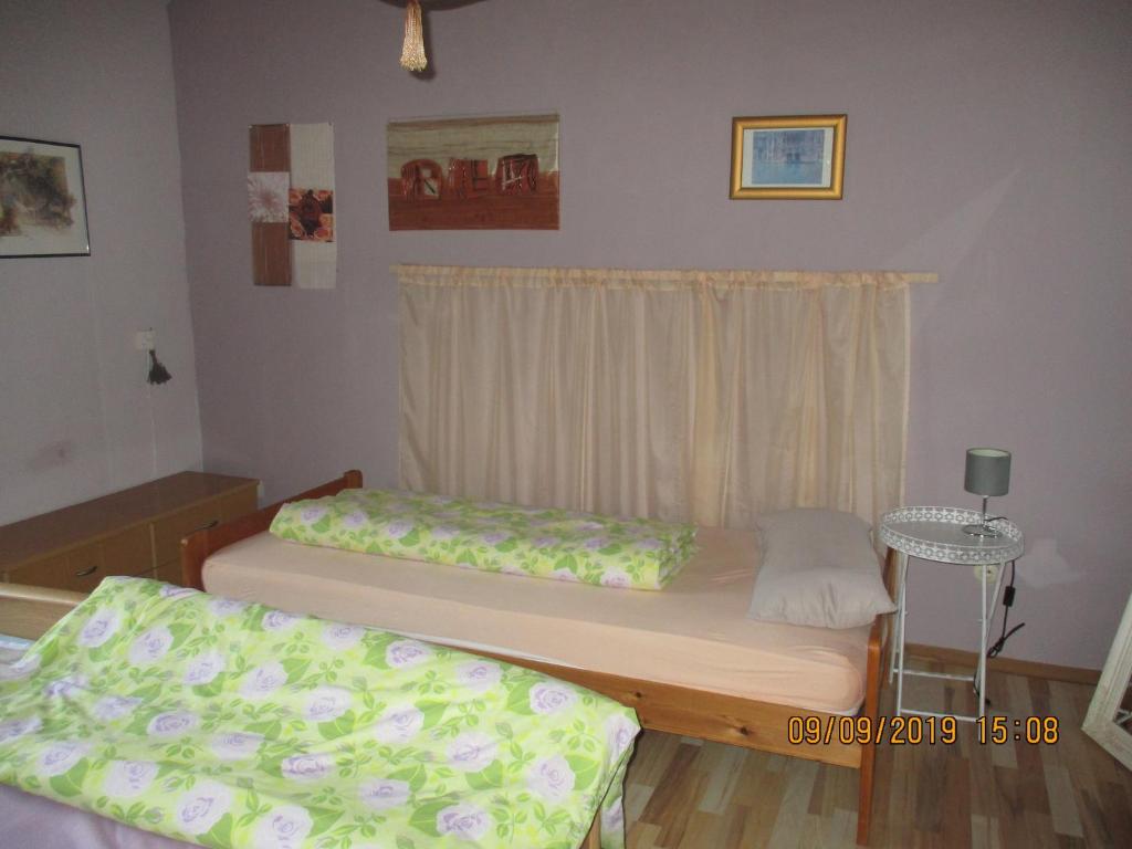 a bedroom with two beds and a window at Ferienwohnung Troglauer in Letzau
