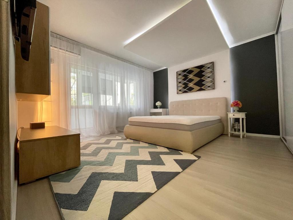 a bedroom with a bed and a large window at Start Apartments 2 in Bucharest
