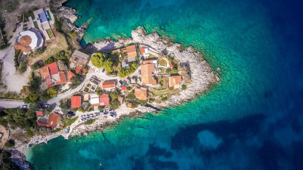 an aerial view of an island in the water at Kokkinos Studios in Skinária